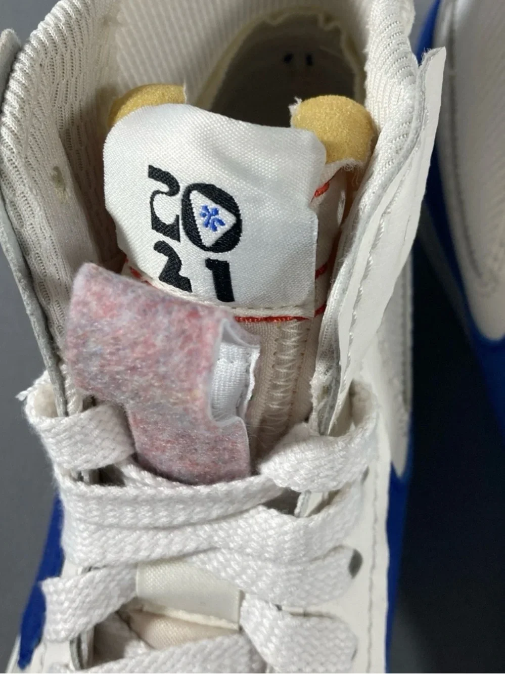 Nike Kids White High-Top Sneakers with Blue Swoosh and Red Stitching